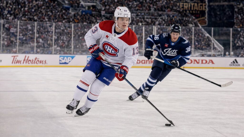 Cole Caufield of the Montreal Canadiens skating with the puck in the outdoor Heritage Classic against the Winnipeg Jets
