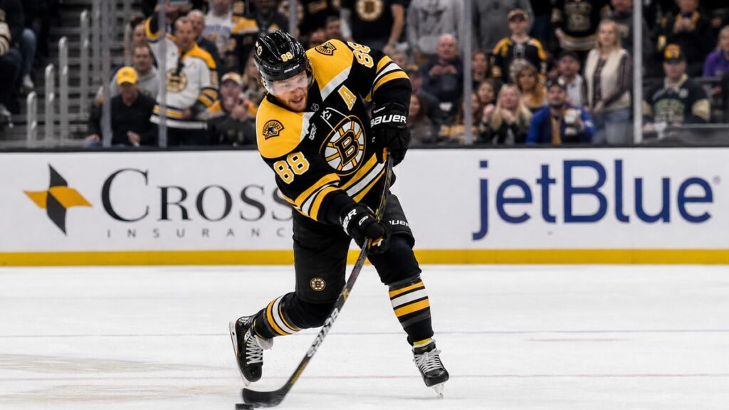 David Pastrnak shooting the puck for the Boston Bruins