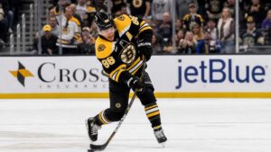 David Pastrnak shooting the puck for the Boston Bruins