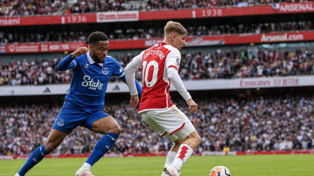 Arsenal player in the red home kit dribbling past an Everton defender at Emirates Stadium