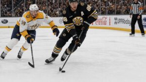 David Pastrnak of the Boston Bruins skating with the puck against the Nashville Predators at TD Garden