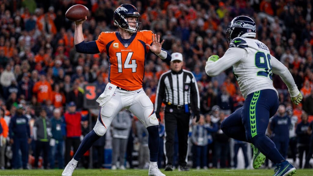 Sam Darnold throwing under pressure from the Seattle Seahawks defense on Thursday Night Football