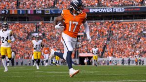 Jaylen Waddle of the Denver Broncos running upfield after a catch at Empower Field at Mile High